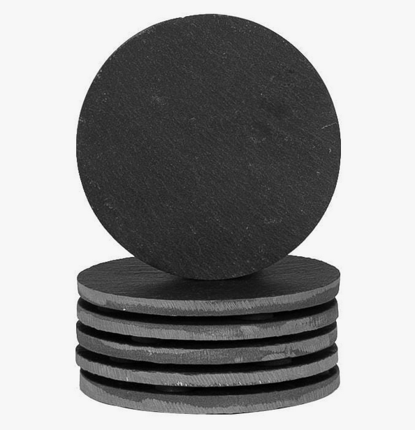 Stack of round black slate coasters from Acier Manufacturing Limited